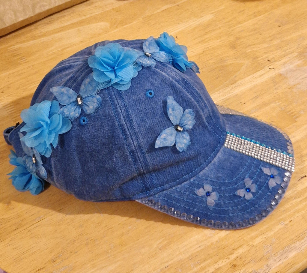 Blue distressed denim baseball cap with nature inspired embellishments