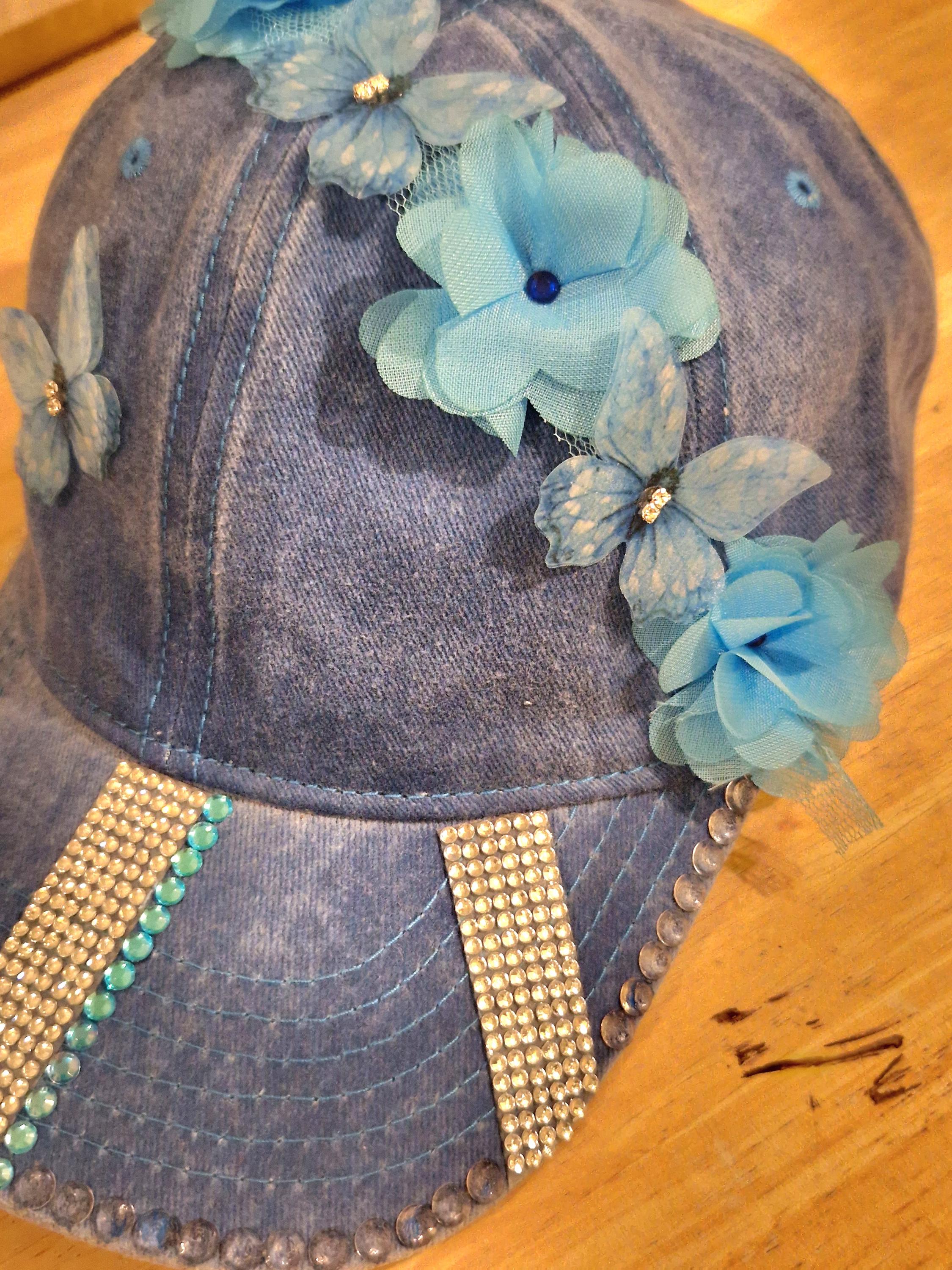 Blue distressed denim baseball cap with nature inspired embellishments