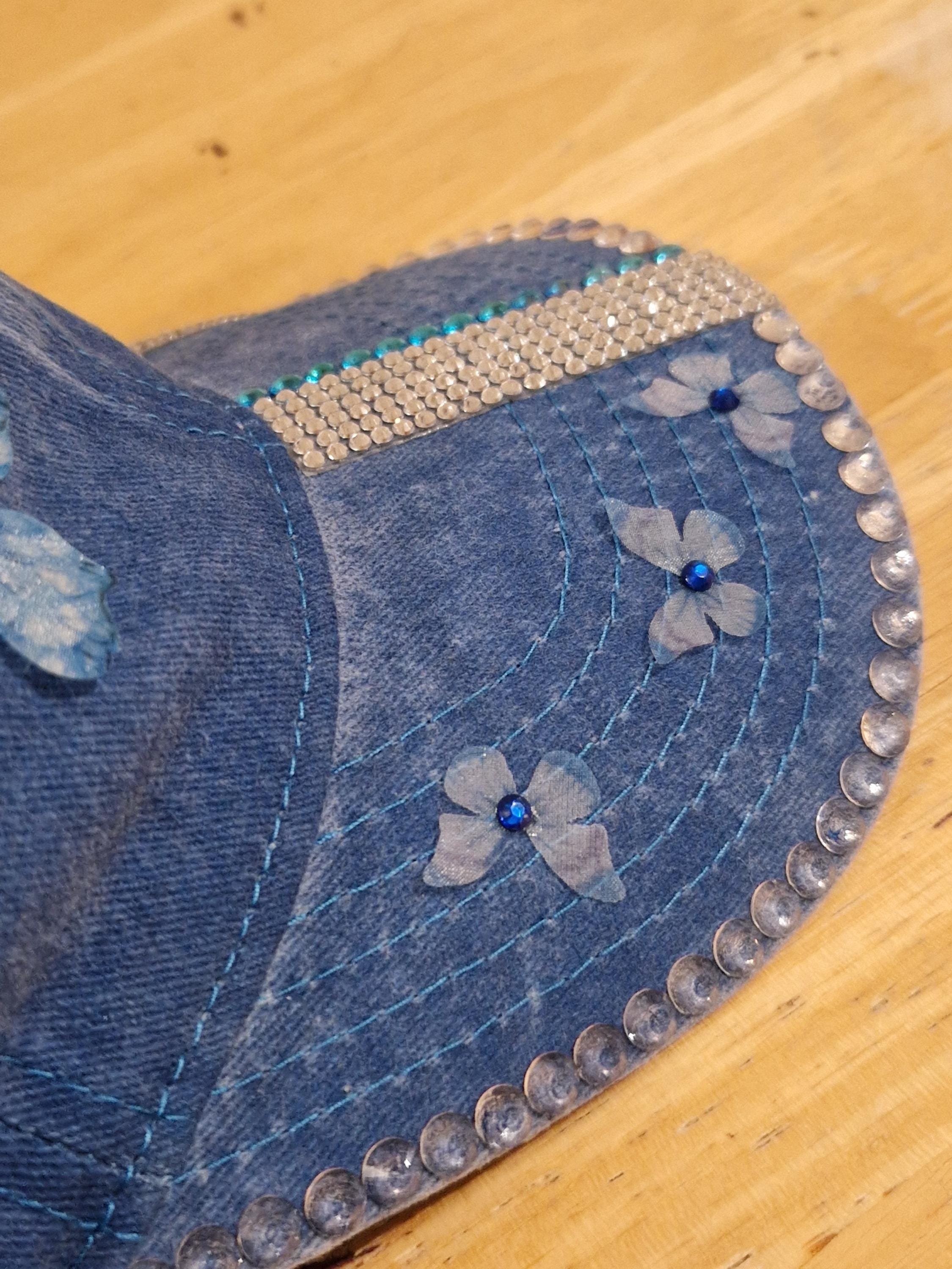 Blue distressed denim baseball cap with nature inspired embellishments